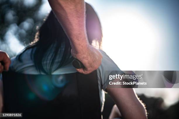 close up of human hand helping woman in wheelchair outdoors - pushman stock pictures, royalty-free photos & images