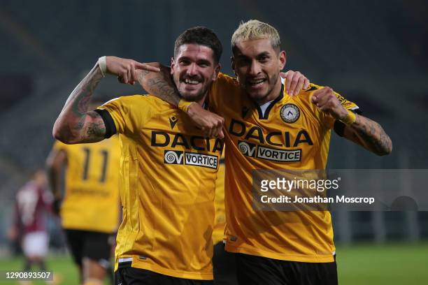 Rodrigo De Paul of Udinese Calcio celebrates with team mate Roberto Pereyra after scoring to give the side a 2-0 lead during the Serie A match...