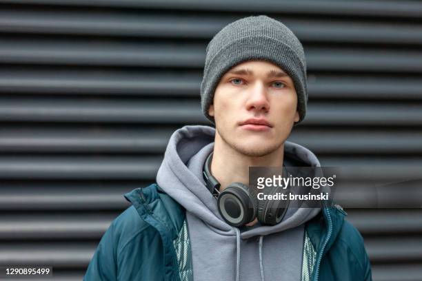 close up outdoors portrait of 18 year old man - winter hat stock pictures, royalty-free photos & images