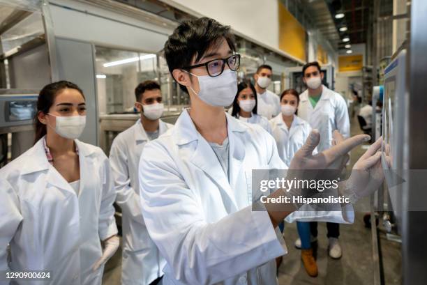 group of college students in a chemistry lab and wearing facemasks - biosecurity stock pictures, royalty-free photos & images