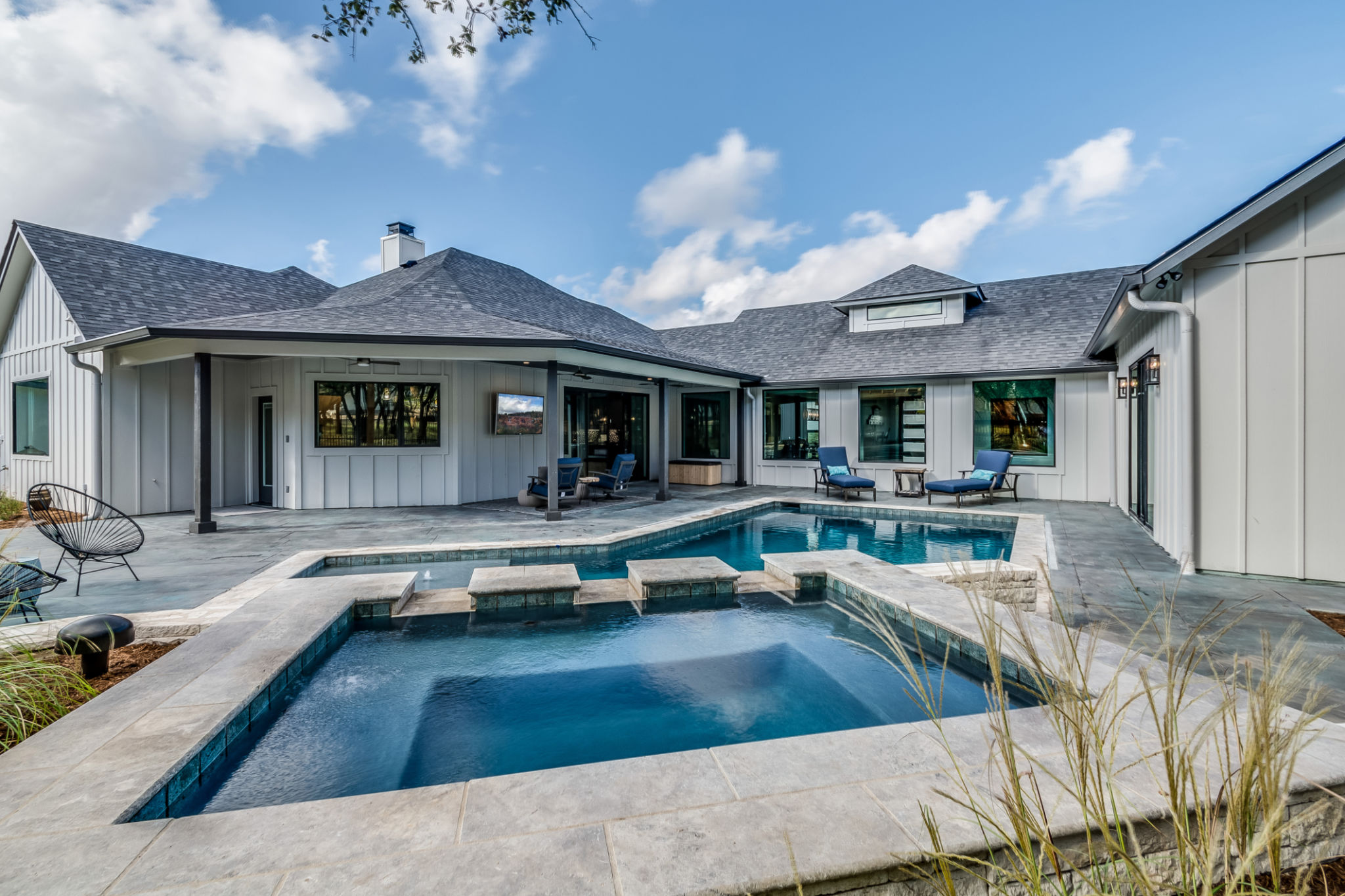 Custom designed swimming pool in backyard of house Custom designed swimming pool in backyard of house