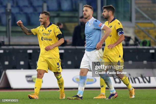 Federico Dimarco and Miguel Veloso of Hellas Verona F.C. Celebrate after Manuel Lazzari of SS Lazio scored an own goal to make it the first goal for...