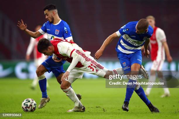 Nicolas Tagliafico of Ajax battles for the ball with Mustafa Saymak and Jesper Drost of PEC Zwolle during the Dutch Eredivisie match between Ajax and...