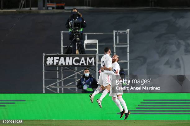 Daniel Carvajal of Real Madrid celebrates with teammate Sergio Ramos after Jan Oblak of Atletico de Madrid scored an own goal to make it the second...