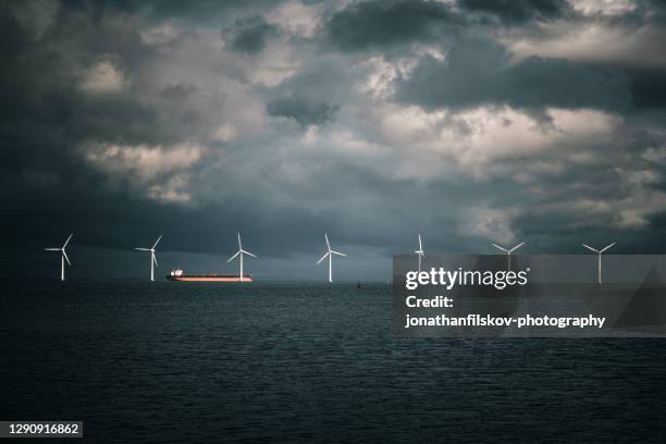 wind turbines in the ocean and coaster - propeller ship stock pictures, royalty-free photos & images