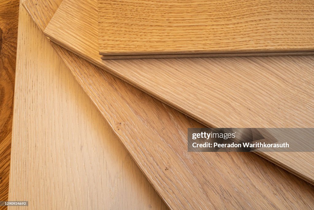 Top view, selective focus of light Engineered hardwood or laminate flooring samples.