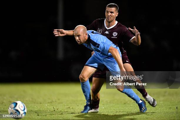 Matt Sim of New South Wales controls the ball under pressure from Corey Sewell of Queensland during the NPL match as part of the Kappa Festival of...