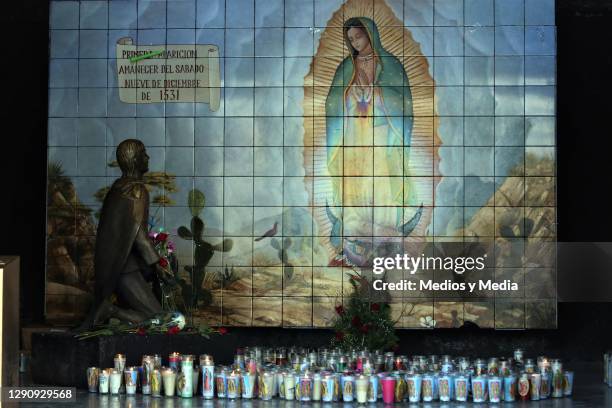 Votive candles are set down an image of the Virgin of Guadalupe on December 12, 2020 in Monterrey, Mexico.Due to the Coronavirus pandemic, the...