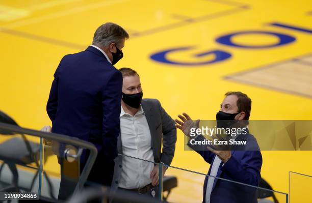 Golden State Warriors owner Joe Lacob talks to his son Kirk Lacob and team president Rick Welts on the court before their NBA preseason game against...
