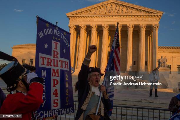 President Donald Trump supporters demonstrating against the election results march to the Supreme Court to protest against the Court's decision not...
