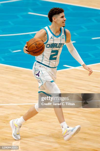 LaMelo Ball of the Charlotte Hornets dribbles during the second half of their game against the Toronto Raptors at Spectrum Center on December 12,...