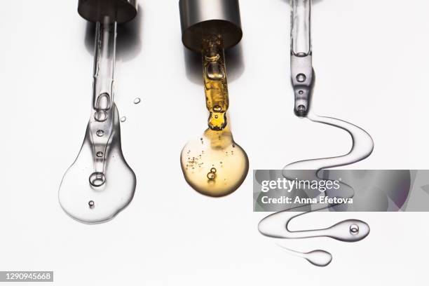 group of pipettes with serum and oil for face. popular beauty products of the year - popular science stock pictures, royalty-free photos & images