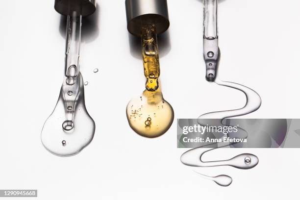 group of pipettes with serum and oil for face. popular beauty products of the year - retinol stock pictures, royalty-free photos & images