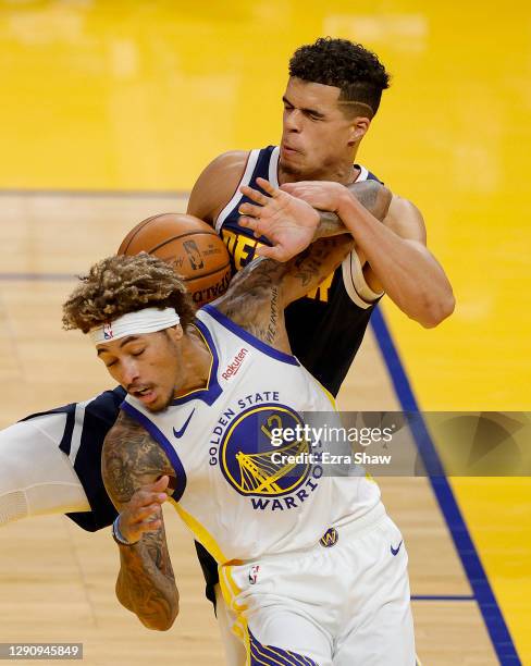 Michael Porter Jr. #1 of the Denver Nuggets and Kelly Oubre Jr. #12 of the Golden State Warriors go for a rebound during their NBA preseason game at...