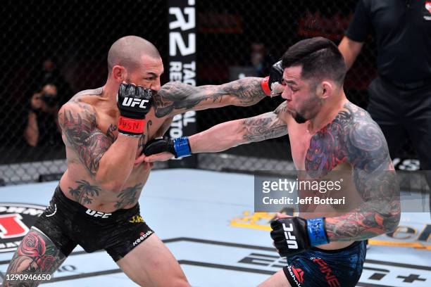 Cub Swanson punches Daniel Pineda in their featherweight bout during the UFC 256 event at UFC APEX on December 12, 2020 in Las Vegas, Nevada.