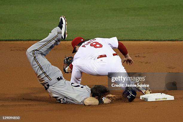 Mark Kotsay of the Milwaukee Brewers face plants on the infield dirt as he is forced out on a double play in the top of the first inning against Nick...