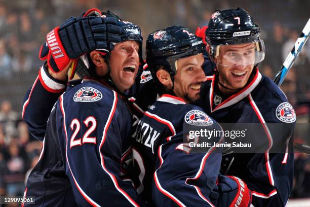 Radek Martinek of the Columbus Blue Jackets is congratulated by teammates Vinny Prospal and Jeff Carter after scoring against the Colorado Avalanche...