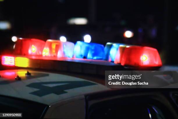 flashing lights on a police car - politiedienst stockfoto's en -beelden