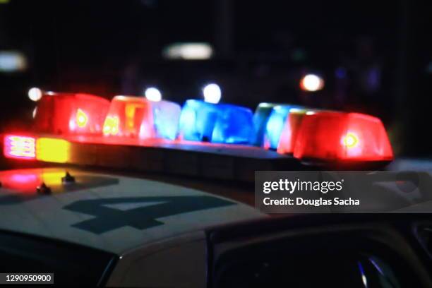 flashing lights on a police car - arrest stock pictures, royalty-free photos & images