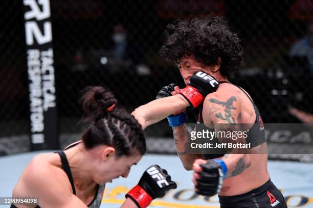 Mackenzie Dern punches Virna Jandiroba of Brazil in their women's strawweight bout during the UFC 256 event at UFC APEX on December 12, 2020 in Las...