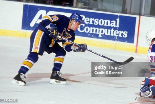 Rod Brind'Amour of the St. Louis Blues takes the shot during an NHL game against the New York Rangers on January 9, 1991 at the Madison Square Garden...