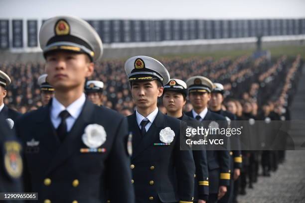 People attend the national memorial ceremony for the Nanjing Massacre victims at the Memorial Hall of the Victims of the Nanjing Massacre by Japanese...