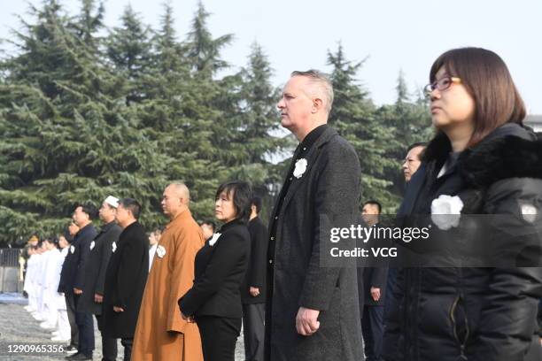 People attend the national memorial ceremony for the Nanjing Massacre victims at the Memorial Hall of the Victims of the Nanjing Massacre by Japanese...
