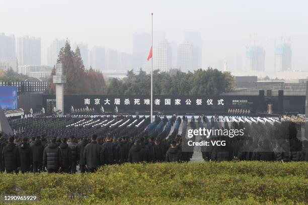 People attend the national memorial ceremony for the Nanjing Massacre victims at the Memorial Hall of the Victims of the Nanjing Massacre by Japanese...