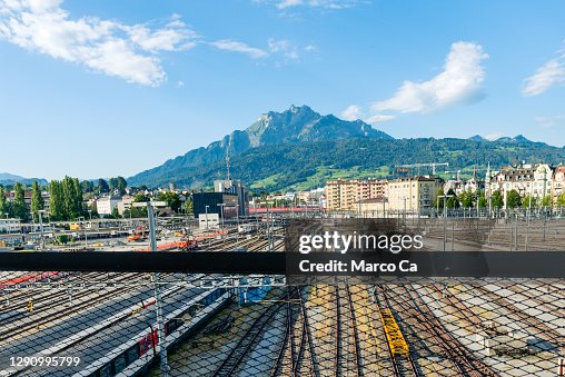 view from the train station in lucerne over the train tracks and the mount pilatus