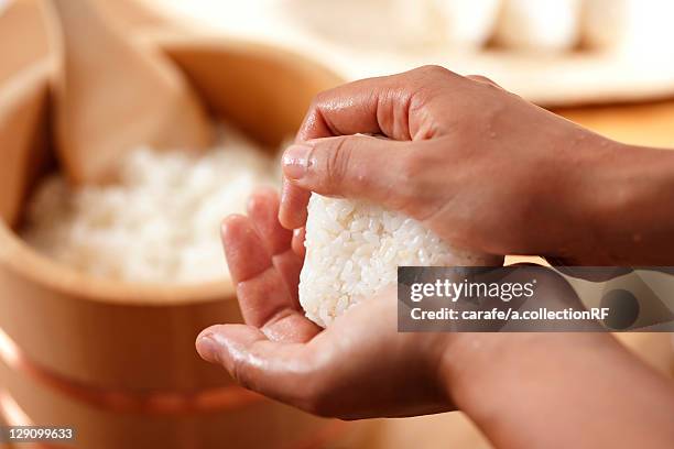 hands making a rice ball - rice ball stock pictures, royalty-free photos & images