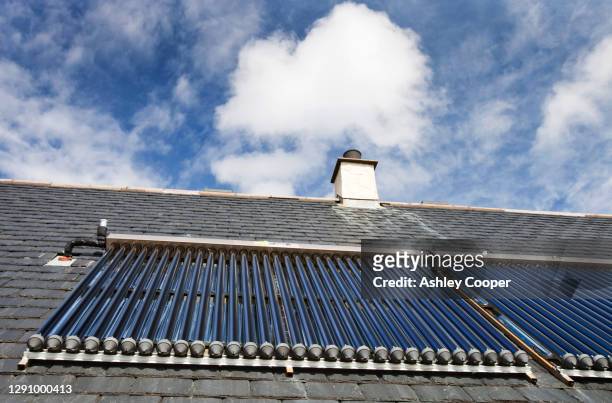 solar thermal panels on a roof on the isle of eigg, scotland, uk. - zonne eiland stockfoto's en -beelden