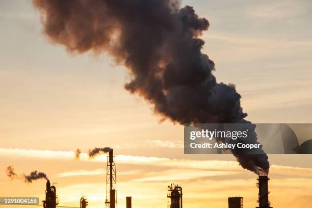 a tar sands upgrader plant north of fort mcmurray, alberta, canada, at sunset. - oil sands stock pictures, royalty-free photos & images