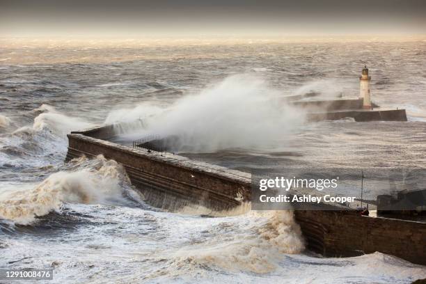 storm waves from an extreme low pressure system batter whitehaven harbour, cumbria, uk, on the 10th december 2014. - bomb cyclone stock pictures, royalty-free photos & images