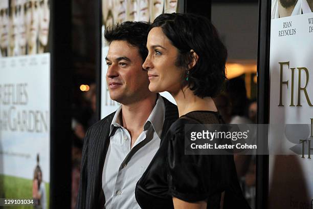 Actress Carrie-Anne Moss and husband Steven Roy arrive at "Fireflies In The Garden" premiere at the Pacific Theater at the Grove on October 12, 2011...