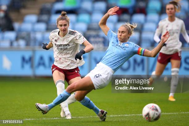 Vivanne Miedema of Arsenal FC scores their team's first goal past Steph Houghton of Manchester City during the Barclays FA Women's Super League match...