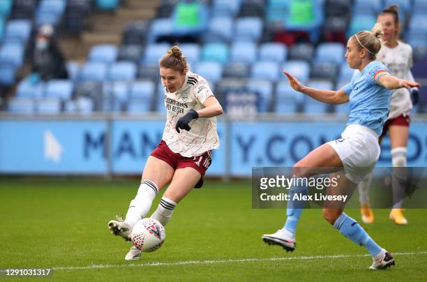 Vivanne Miedema of Arsenal FC scores their team's first goal past Steph Houghton of Manchester City during the Barclays FA Women's Super League match...