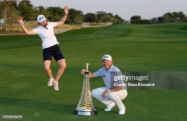 Lee Westwood of England and his girlfriend and caddie, Helen Storey pictured with the Race to Dubai trophy after the final round of the DP World Tour...