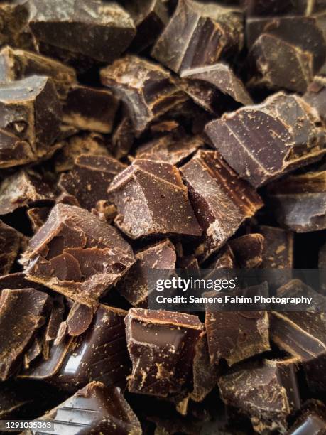 close-up of dark chocolate chips - chocolate chips stock pictures, royalty-free photos & images
