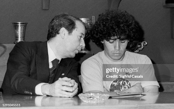 The Argentinian football star Diego Armando Maradona listens to the advice of the president of F.C. Barcelona, Josep Lluís Nuñez, during the signing...