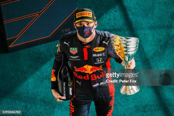 Race winner Max Verstappen of Netherlands and Red Bull Racing celebrates on the podium during the F1 Grand Prix of Abu Dhabi at Yas Marina Circuit on...