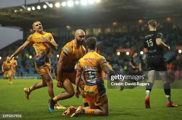 Stuart Hogg of Exeter Chiefs celebrates after scoring their third try with Olly Woodburn and Henry Slade during the Heineken Champions Cup Pool 2...