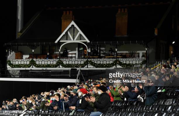 Fans show their support prior to the Premier League match between Fulham and Liverpool at Craven Cottage on December 13, 2020 in London, England. A...