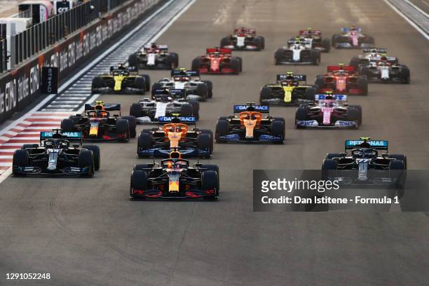 Max Verstappen of the Netherlands driving the Aston Martin Red Bull Racing RB16 leads Lewis Hamilton of Great Britain driving the Mercedes AMG...