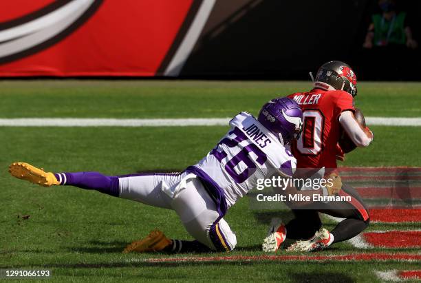 Scott Miller of the Tampa Bay Buccaneers catches a touchdown pass while covered by Chris Jones of the Minnesota Vikings at Raymond James Stadium on...