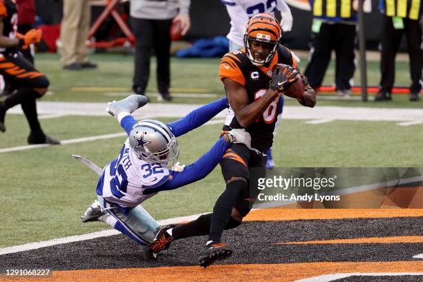 Green of the Cincinnati Bengals catches a touchdown pass while being guarded by Saivion Smith of the Dallas Cowboys in the second quarter at Paul...