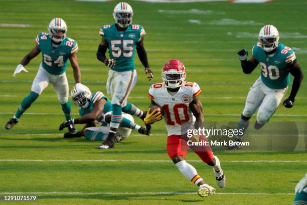 Tyreek Hill of the Kansas City Chiefs carries the ball against the Miami Dolphins during the first half of the game at Hard Rock Stadium on December...