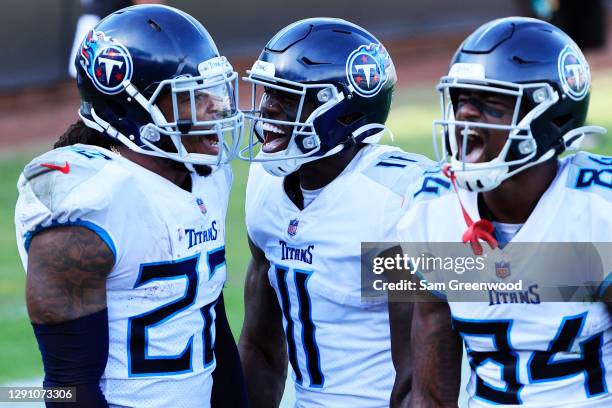 Derrick Henry of the Tennessee Titans celebrates with A.J. Brown and Corey Davis after scoring a touchdown against the Jacksonville Jaguars in the...