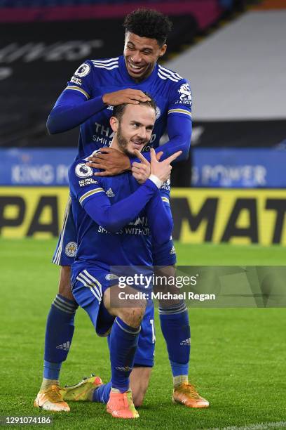 James Maddison of Leicester City celebrates with teammate James Justin after scoring their team's third goal during the Premier League match between...