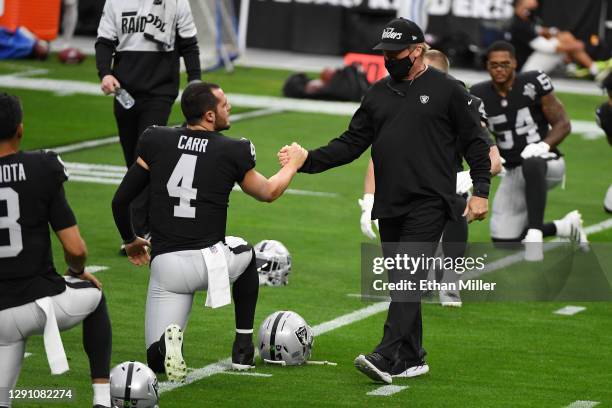 Las Vegas Raiders head coach Jon Gruden greets quarterback Derek Carr during warmups against the Indianapolis Colts at Allegiant Stadium on December...