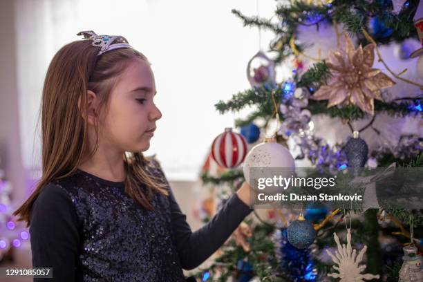 little girl next to christmas tree - christmas tree close up stock pictures, royalty-free photos & images